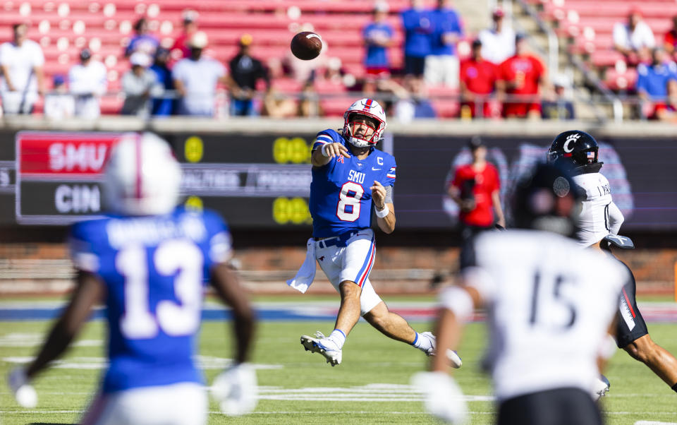 SMU quarterback Tanner Mordecai (8) throws to SMU wide receiver Roderick Daniels Jr. (13) during the first half of an NCAA college football game against Cincinnati Saturday, Oct. 22, 2022, in Dallas. (AP Photo/Brandon Wade)