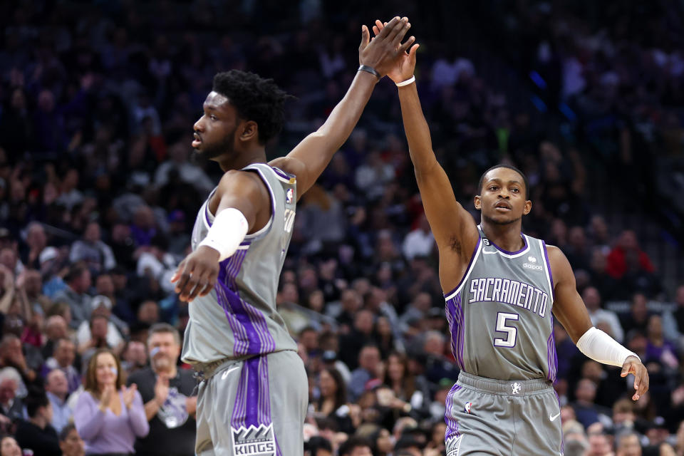 SACRAMENTO, CALIFORNIA - NOVEMBER 15: De'Aaron Fox #5 of the Sacramento Kings high-fives Chimezie Metu #7 after Fox made a shot at the end of the first quarter against the Brooklyn Nets at Golden 1 Center on November 15, 2022 in Sacramento, California. NOTE TO USER: User expressly acknowledges and agrees that, by downloading and or using this photograph, User is consenting to the terms and conditions of the Getty Images License Agreement. (Photo by Ezra Shaw/Getty Images)