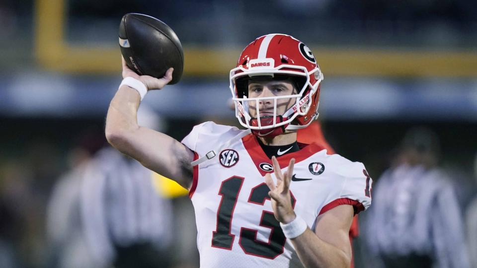 Georgia quarterback Stetson Bennett (13) tosses a pass during warmups prior to an NCAA college football game against Mississippi State in Starkville, Miss., Saturday, Nov. 12, 2022. Georgia won 45-19. (AP Photo/Rogelio V. Solis)