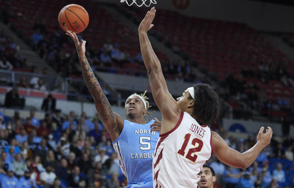 North Carolina forward Armando Bacot, left, shoots over Iowa State forward Robert Jones during the first half of an NCAA college basketball game in the Phil Knight Invitational tournament in Portland, Ore., Friday, Nov. 25, 2022. (AP Photo/Craig Mitchelldyer)