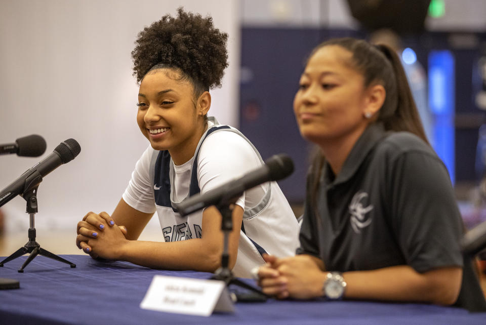 CHATSWORTH, CA - OCTOBER 27, 2021: JuJu Watkins, left, a member of the Sierra High School girls basketball team, and head coach Alicia Komaki take questions from reporters during media day inside the schools gymnasium. (Mel Melcon / Los Angeles Times via Getty Images)