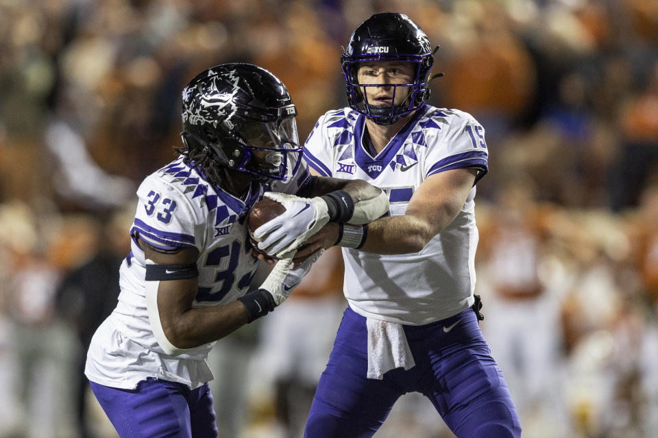 TCU quarterback Max Duggan (15) hands off to running back Kendre Miller (33) during the first half of the team's NCAA college football game against Texas on Saturday, Nov. 12, 2022, in Austin, Texas. (AP Photo/Stephen Spillman)