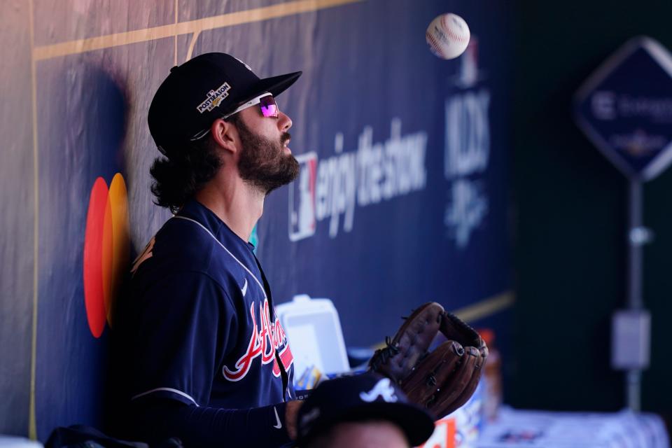 Atlanta Braves Dansby Swanson (7) tosses a ball in the dugout before Game 4 of baseball's National League Division Series between the Philadelphia Phillies and the Atlanta Braves, Saturday, Oct. 15, 2022, in Philadelphia. (AP Photo/Matt Slocum)