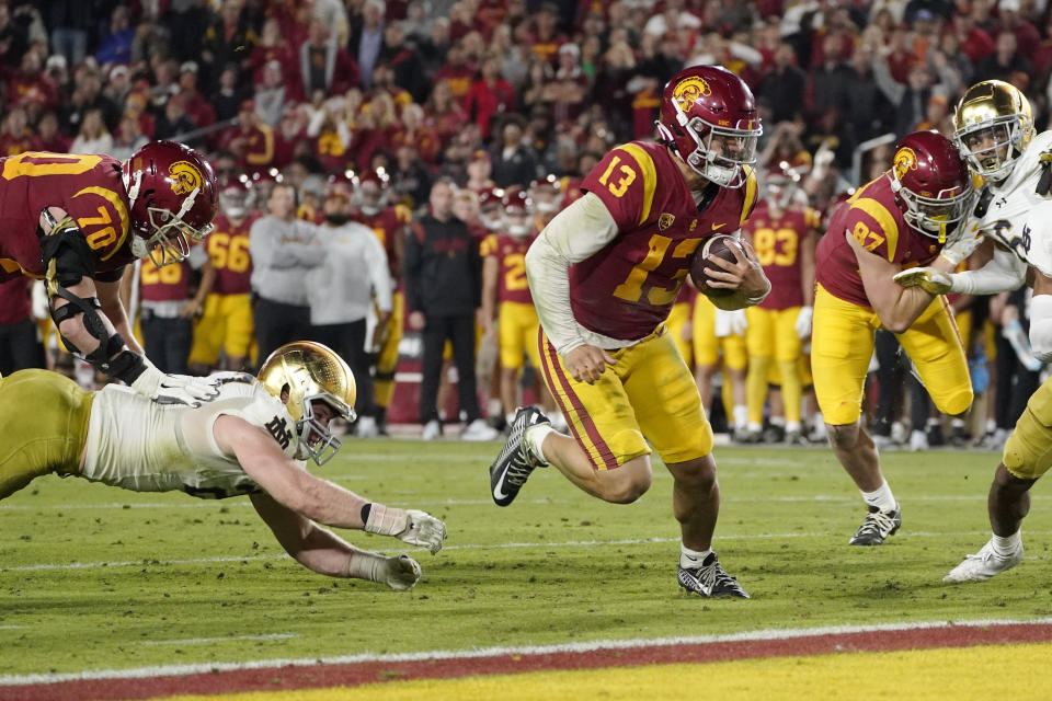 USC quarterback Caleb Williams (13) runs in for a touchdown against Notre Dame Saturday, Nov. 26, 2022, in Los Angeles. (AP Photo/Mark J. Terrill)