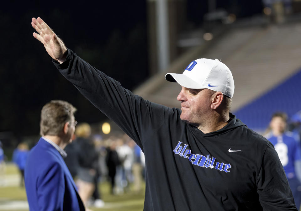 Duke head coach Mike Elko waves to fans as he walks off the field after earning a victory over Wake Forest in Durham, N.C., Saturday, Nov. 26, 2022. (AP Photo/Ben McKeown)