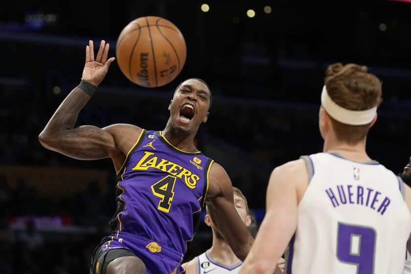 Los Angeles Lakers guard Lonnie Walker IV, left, celebrates after dunking as Sacramento Kings guard Kevin Huerter.