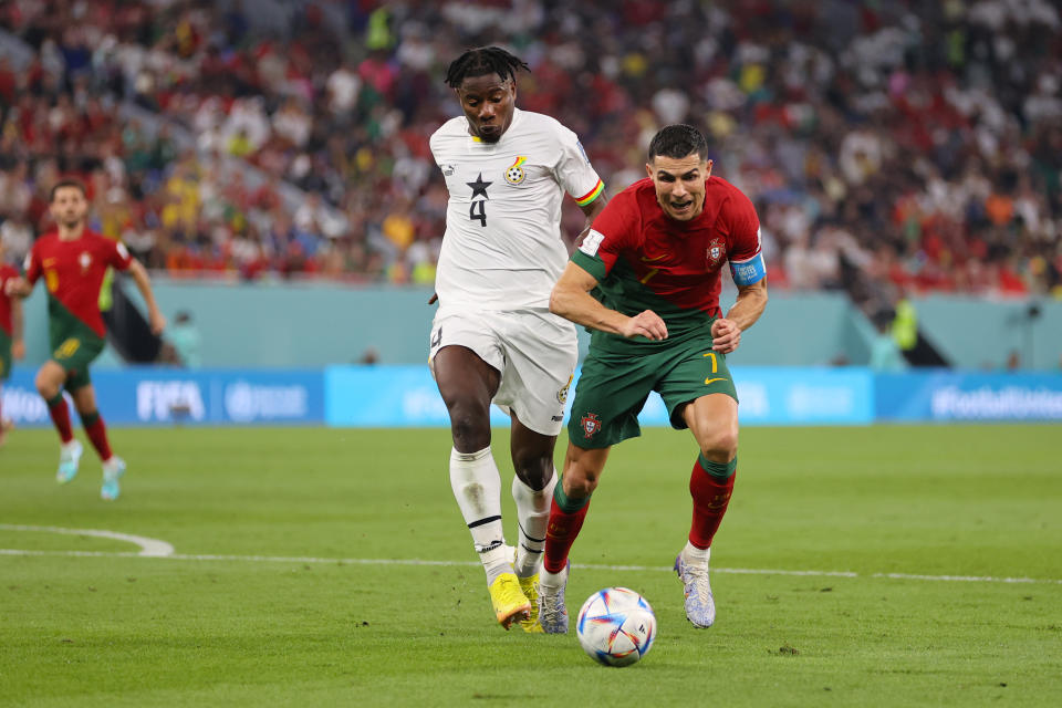 DOHA, QATAR - NOVEMBER 24: Cristiano Ronaldo of Portugal is brought down by Mohammed Salisu of Ghana during the FIFA World Cup Qatar 2022 Group H match between Portugal and Ghana at Stadium 974 on November 24, 2022 in Doha, Qatar. (Photo by Clive Brunskill/Getty Images)