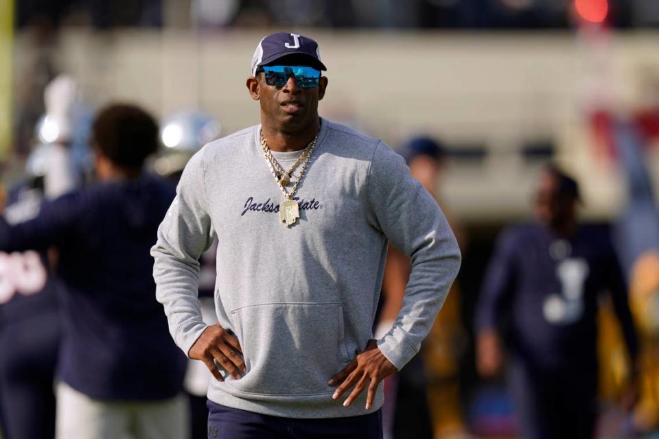 Jackson State coach Deion Sanders watches players warm up for the Southwestern Athletic Conference championship NCAA college football game against Southern, Saturday, Dec. 3, 2022, in Jackson, Miss. Sanders is taking over as coach at Colorado, bringing his charisma and larger-than-life persona to a beleaguered Pac-12 program that’s plunged to the bottom of college football. The deal was announced Saturday night by CU athletic director Rick George. (AP Photo/Rogelio V. Solis)