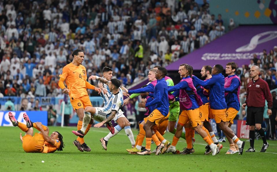 Dutch subs run onto the pitch to confront Argentina's players - Matthias Hangst/Getty Images