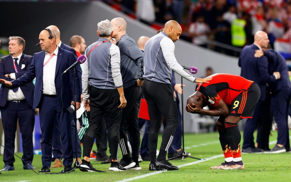 Belgium's assistant coach Thierry Henry (2-R) comforts Romelu Lukaku - SHUTTERSTOCK