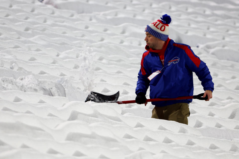 Stadium workers clear snow off the field prior to a game between the Miami Dolphins and Buffalo Bills at Highmark Stadium. (Photo by Timothy T Ludwig/Getty Images)