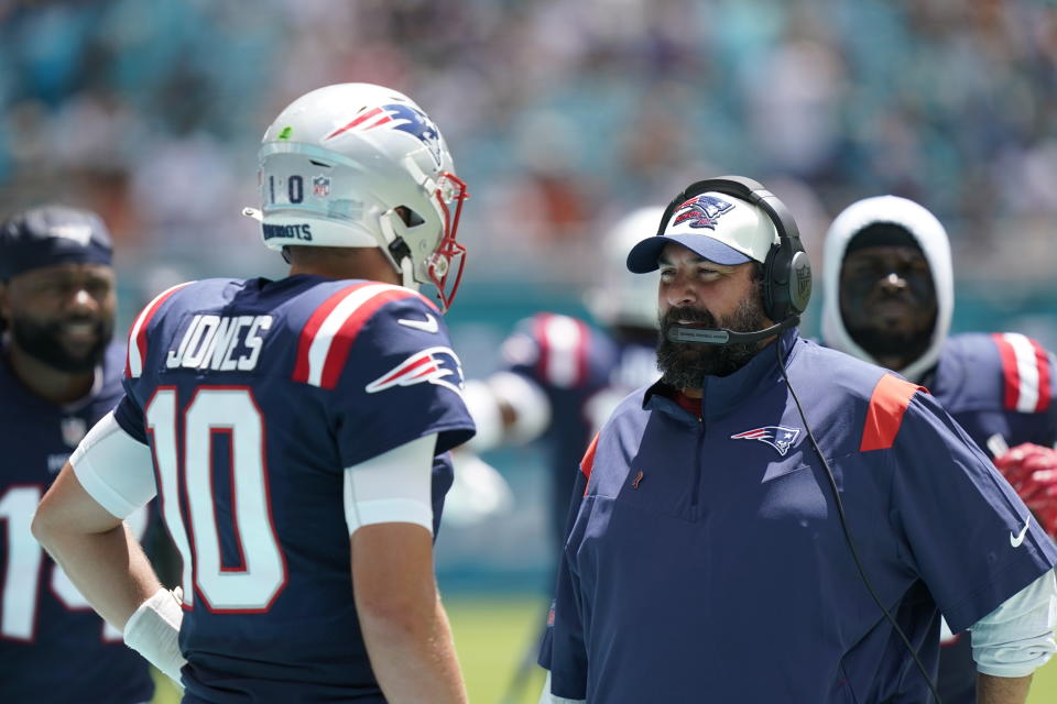 New England Patriots quarterback Mac Jones (10) talks to Senior football advisor Matt Patricia during the first half of an NFL football game against the Miami Dolphins, Sunday, Sept. 11, 2022, in Miami Gardens, Fla. (AP Photo/Lynne Sladky)