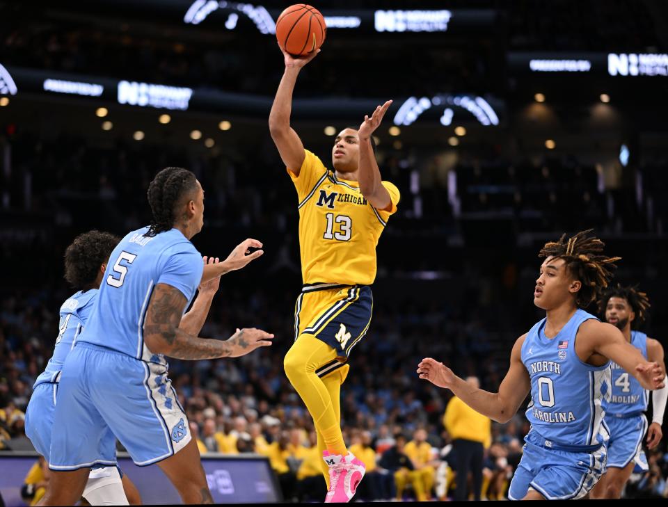 Michigan's Jett Howard takes a shot over North Carolina's Armando Bacot during the first half on Wednesday, Dec. 21, 2022, in Charlotte, North Carolina.