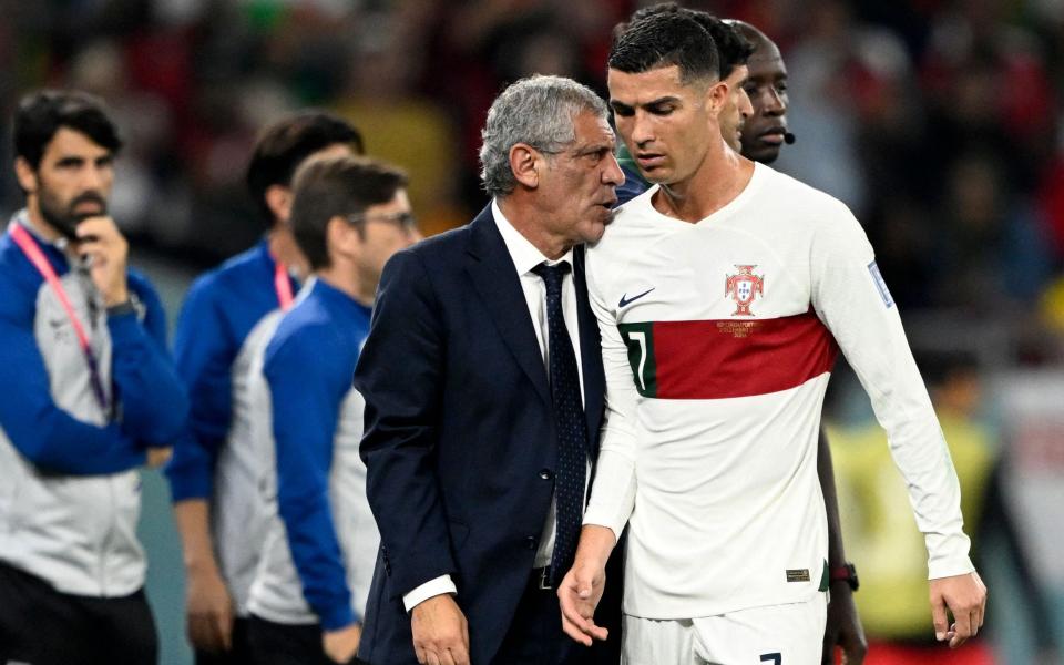 Portugal's coach #00 Fernando Santos (L) greets Portugal's forward #07 Cristiano Ronaldo as he leaves the pitch during the Qatar 2022 World Cup Group H football match between South Korea and Portugal at the Education City Stadium in Al-Rayyan, west of Doha on December 2, 2022 - Patricia De Melo More/Getty Images