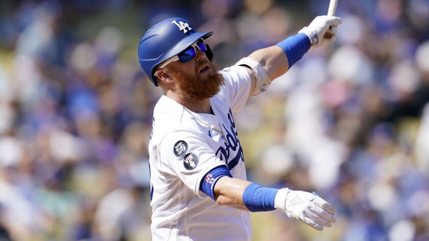 Los Angeles Dodgers' Justin Turner hits during a baseball game against the Colorado Rockies.