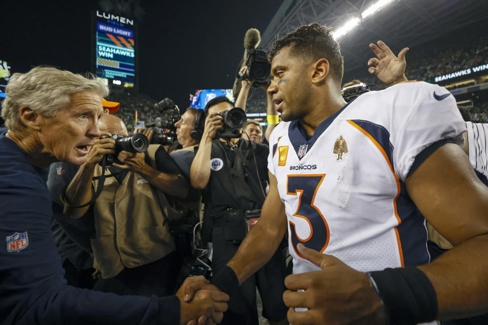 SEATTLE, WASHINGTON - SEPTEMBER 12: Head coach Pete Carroll of the Seattle Seahawks and Russell Wilson #3 of the Denver Broncos shake hands after their game at Lumen Field on September 12, 2022 in Seattle, Washington. (Photo by Steph Chambers/Getty Images)