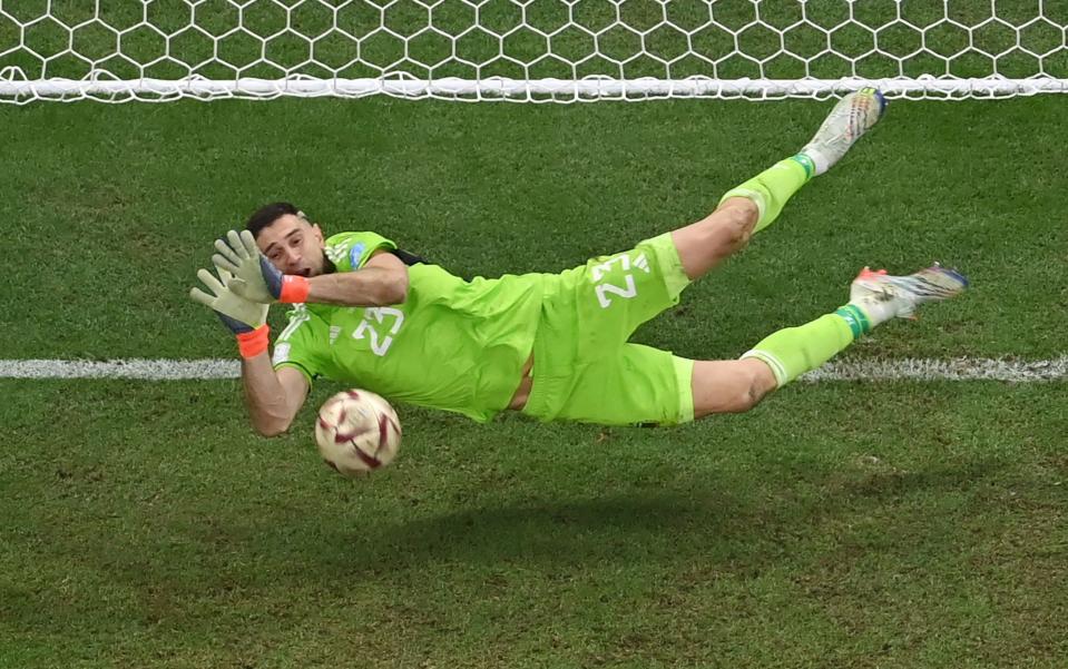 Emiliano Martinez stops France's forward #20 Kingsley Coman's shot during the penalty shootout during - Jewel Samad /AFP