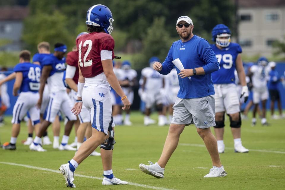 Kentucky offensive coordinator Liam Coen runs a drill in 2021.