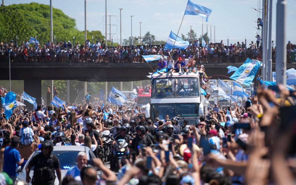 The Argentine soccer team that won the World Cup title ride on an open bus during their homecoming parade in Buenos Aires, Argentina - AP