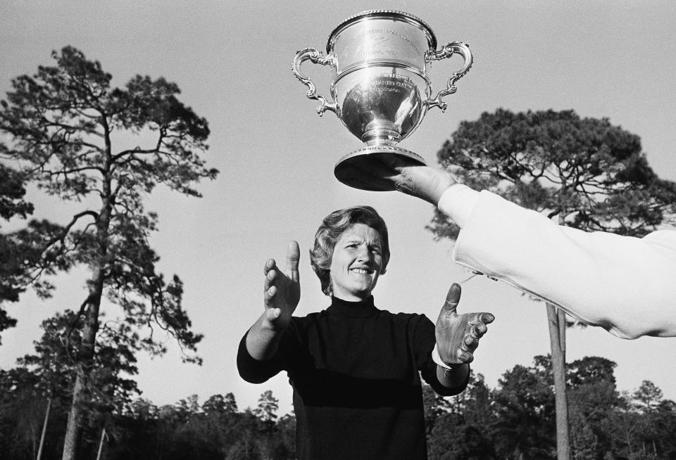 Kathy Whitworth of San Antonio, Tex., holds out her arms to winners cup as she leads the field of 36 going into the final round Sunday, Nov. 27, 1965 with a 54 hole total of 216 in Women's Titleholders Golf Tournament at Augusta, Ga. (AP Photo/Horace Cort)