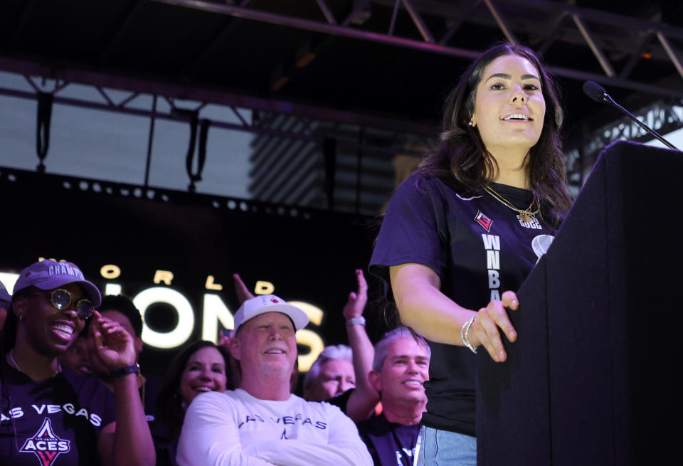 Las Vegas Aces guard Kelsey Plum speaks during the team's WNBA championship victory parade in front of Aces owner Mark Davis on Sept. 20, 2022 in Las Vegas. (Ethan Miller/Getty Images)