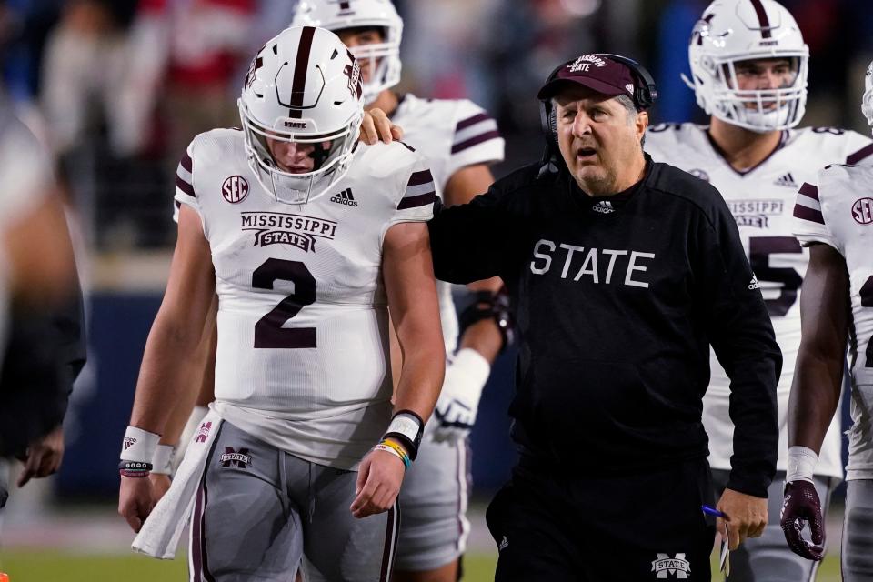 Mississippi State coach Mike Leach confers with quarterback Will Rogers (2) during the first half of the team's NCAA college football game against Mississippi in Oxford on Thursday, Nov. 24.
