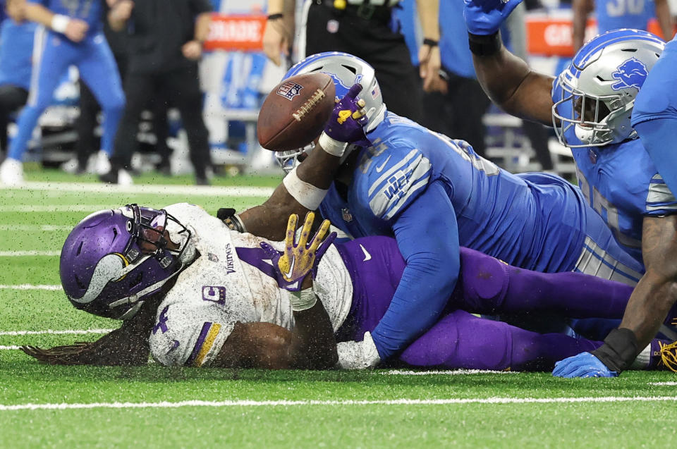 Minnesota Vikings running back Dalvin Cook fumbles as he is hit by Detroit Lions defender Isaiah Buggs. (Photo by Rey Del Rio/Getty Images)