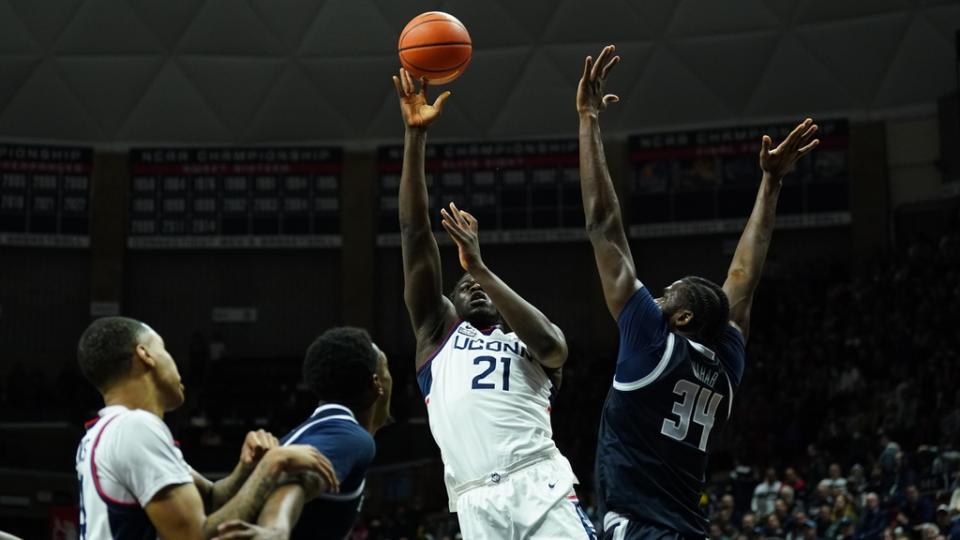 Dec 20, 2022; Storrs, Connecticut, USA; UConn Huskies forward Adama Sanogo (21) shoots against Georgetown Hoyas center Qudus Wahab (34) in the first half at Harry A. Gampel Pavilion