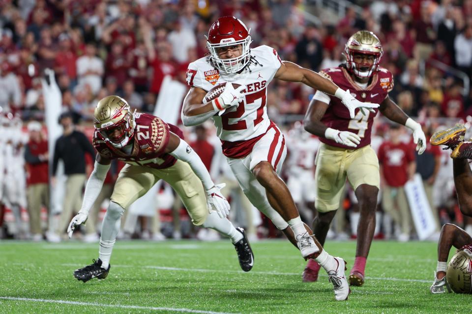 Dec 29, 2022; Orlando, Florida, USA; Oklahoma Sooners running back Gavin Sawchuk (27) runs with the ball against the Florida State Seminoles in the second quarter during the 2022 Cheez-It Bowl at Camping World Stadium. Mandatory Credit: Nathan Ray Seebeck-USA TODAY Sports