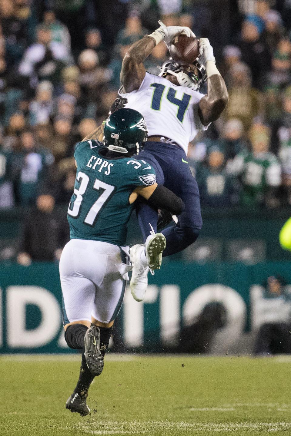 Seattle's DK Metcalf (14) makes a jumping catch over Philadelphia's Marcus Epps (37) in a Jan. 2020 playoff game.