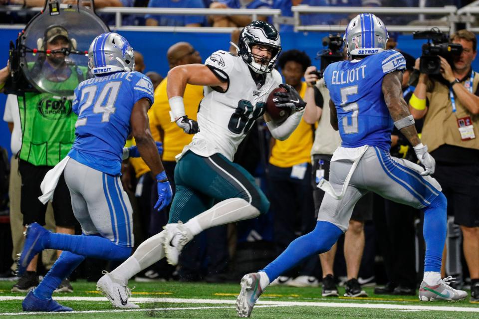 Eagles tight end Dallas Goedert runs against Lions cornerback Amani Oruwariye, left, and safety DeShon Elliott during the first half on Sunday, Sept. 11, 2022, at Ford Field.