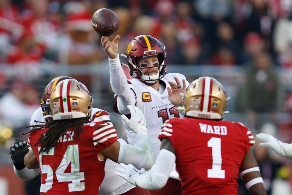 Washington Commanders quarterback Carson Wentz throws a pass as he is pressured by San Francisco 49ers linebacker Fred Warner (54) and cornerback Jimmie Ward (1) in the second half of an NFL football game, Saturday, Dec. 24, 2022, in Santa Clara, Calif. (AP Photo/Jed Jacobsohn)