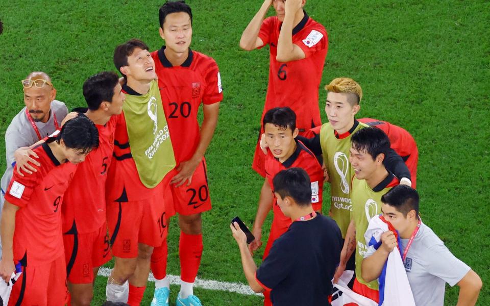 South Korea team members wait for results from the Ghana v Uruguay game - REUTERS