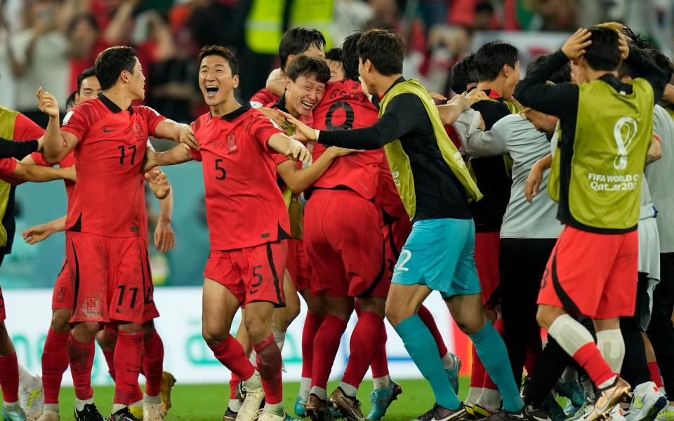 South Korea players celebrate after the World Cup group H soccer match - AP