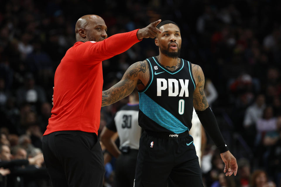 Portland Trail Blazers head coach Chauncey Billups and point guard Damian Lillard talk during a recent game. Lillard's buy-in has been especially important for the second-year head coach. (Steph Chambers/Getty Images)