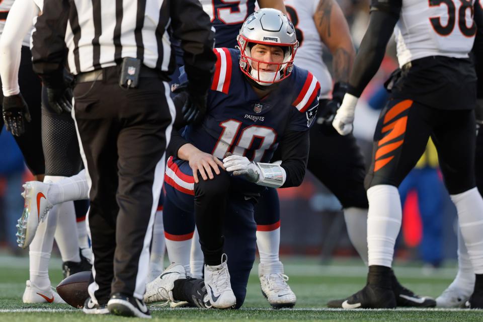 New England Patriots quarterback Mac Jones (10) gets up after being sacked during the second half of an NFL football game against the Cincinnati Bengals, Saturday, Dec. 24, 2022, in Foxborough, Mass. (AP Photo/Michael Dwyer)