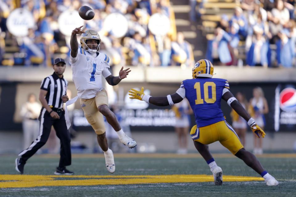 UCLA quarterback Dorian Thompson-Robinson (1) throws under pressure from California linebacker Oluwafemi Oladejo