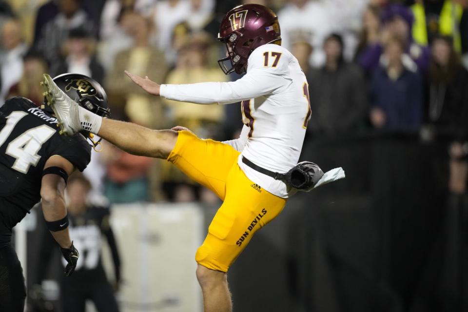 Arizona State place kicker Eddie Czaplicki punts in the second half against Colorado.