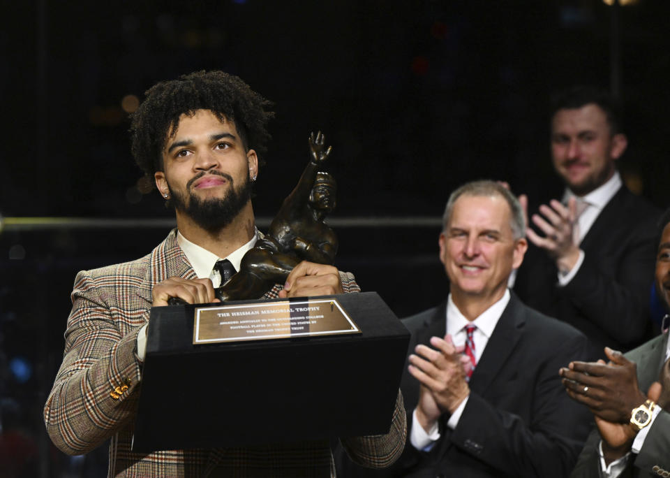 Southern California quarterback Caleb Williams holds the Heisman Trophy after winning the award Saturday, Dec. 10, 2022, in New York. (Todd Van Emst/Pool Photo via AP)