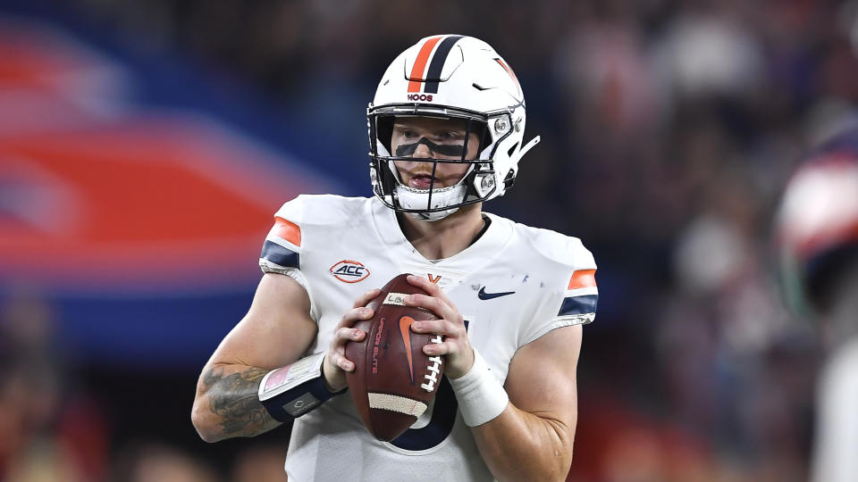 Virginia quarterback Brennan Armstrong (5) looks to pass during the second half of an NCAA college football game against Syracuse on Friday, Sept. 23, 2022 in Syracuse, N.Y. (AP Photo/Adrian Kraus)