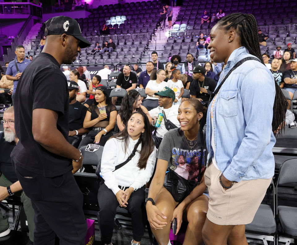 Phoenix Suns point guard Chris Paul, Las Vegas Aces assistant coach Natalie Nakase, Aces forward A'ja Wilson and point guard Chelsea Gray chat on the sideline of an exhibition game between Boulogne-Levallois Metropolitans 92 and G League Ignite at The Dollar Loan Center in Henderson, Nevada, on Oct. 4, 2022. (Ethan Miller/Getty Images)