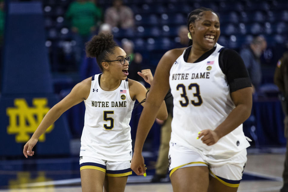 Notre Dame's Olivia Miles and Lauren Ebosmile as they walk off the court after beating Merrimack on Dec. 10, 2022 in South Bend, Indiana. (AP Photo/Michael Caterina)