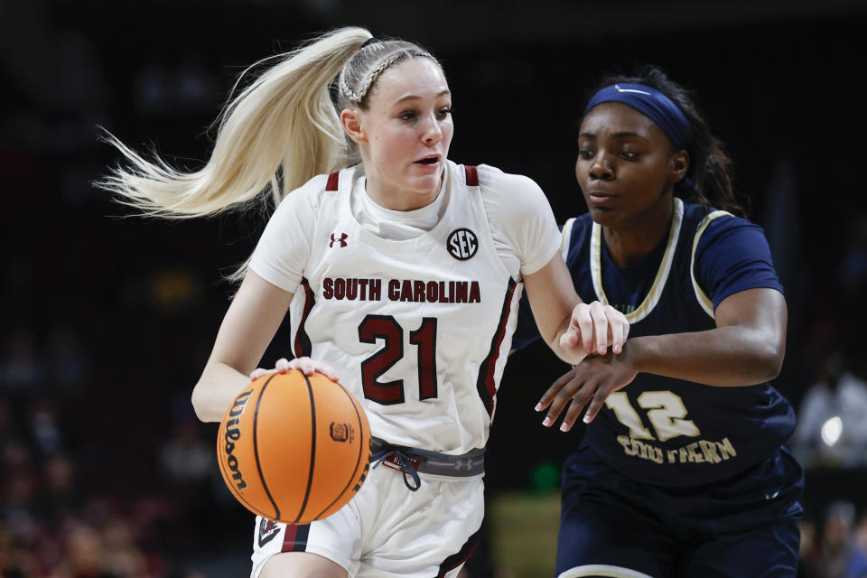 South Carolina forward Chloe Kitts drives against Charleston Southern guard Zaire Hicks in Columbia, South Carolina, on Dec. 18, 2022. South Carolina won 87-23. (AP Photo/Nell Redmond)