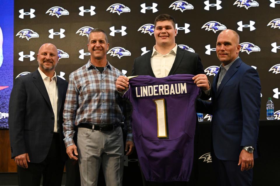 Baltimore Ravens first-round pick Tyler Linderbaum, second from right, is pictured with head coach John Harbaugh, second from left, director of player personnel Joe Hortiz, left, and executive vice president and general manager Eric DeCosta, right.