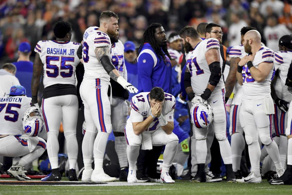 Buffalo Bills quarterback Josh Allen (17) pauses as Damar Hamlin is examined by medical staff during the first half of an NFL football game against the Cincinnati Bengals, Monday, Jan. 2, 2023, in Cincinnati. (AP Photo/Emilee Chinn)