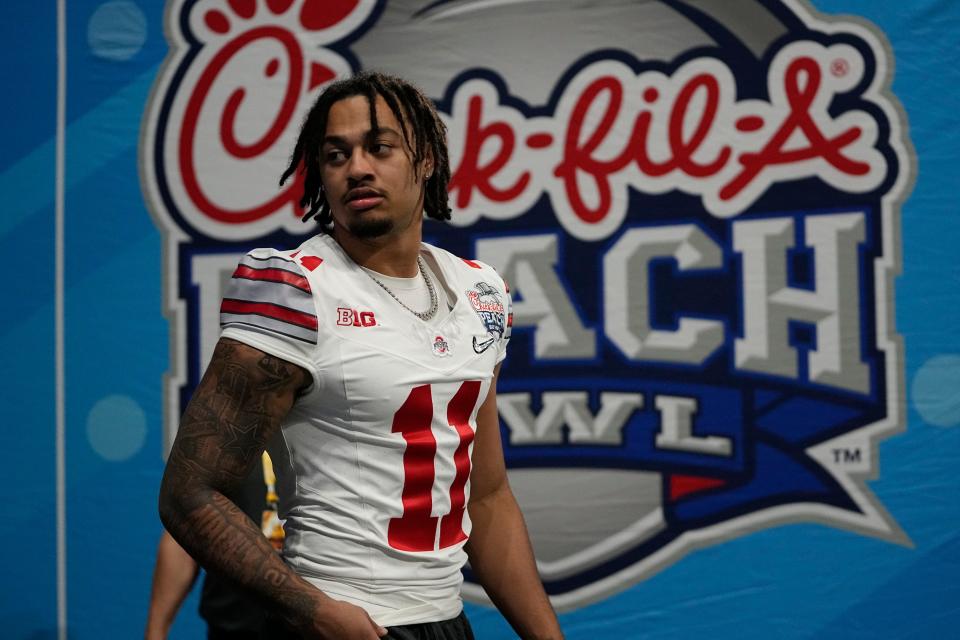 Dec 31, 2022; Atlanta, Georgia, USA; Ohio State Buckeyes wide receiver Jaxon Smith-Njigba (11) walks onto the field prior to the Peach Bowl in the College Football Playoff semifinal at Mercedes-Benz Stadium. Smith-Njigba did not play due to injury. Mandatory Credit: Adam Cairns-The Columbus Dispatch