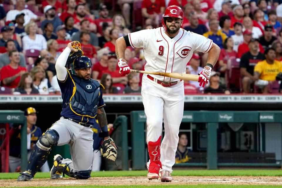 Cincinnati Reds third baseman Mike Moustakas (9) reacts after flying out in the seventh inning during a baseball game against the Milwaukee Brewers, Friday, June 17, 2022, at Great American Ball Park in Cincinnati. 