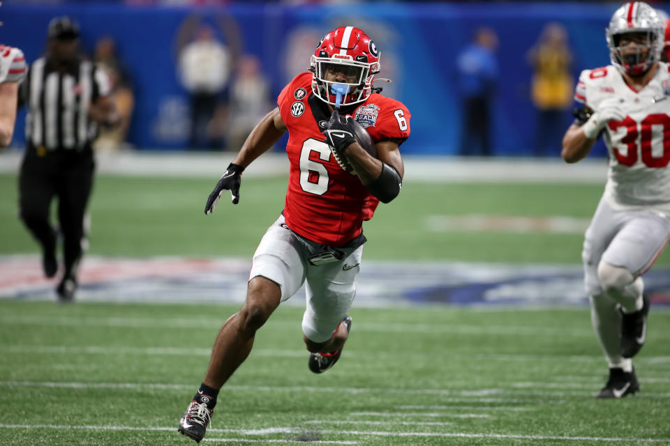 ATLANTA, GA - DECEMBER 31: Georgia Bulldogs running back Kenny McIntosh (6) carries the ball during the college football Playoff Semifinal game at the Chick-fil-a Peach Bowl between the Georgia Bulldogs and the Ohio State Buckeyes on December 31, 2022 at Mercedes-Benz Stadium in Atlanta, Georgia. (Photo by Michael Wade/Icon Sportswire via Getty Images)