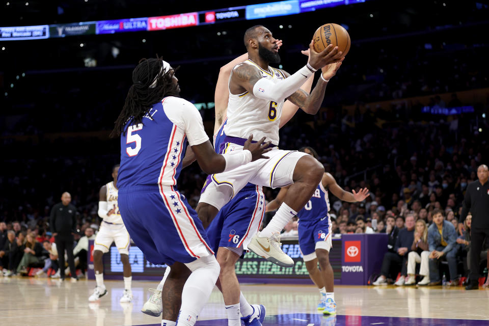 LOS ANGELES, CALIFORNIA - JANUARY 15: LeBron James #6 of the Los Angeles Lakers dribbles to the basket past the defense of Montrezl Harrell #5 of the Philadelphia 76ers during the second half of a game at Crypto.com Arena on January 15, 2023 in Los Angeles, California. NOTE TO USER: User expressly acknowledges and agrees that, by downloading and or using this photograph, User is consenting to the terms and conditions of the Getty Images License Agreement. (Photo by Sean M. Haffey/Getty Images)