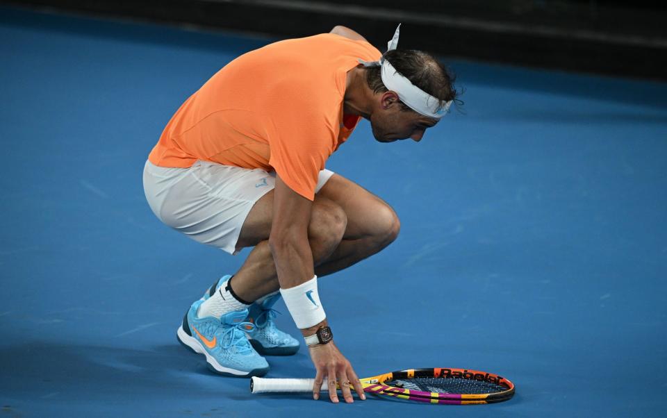 Rafael Nadal of Spain bends over injured during his match against Mackenzie McDonald of the USA during the 2023 Australian Open tennis tournament at Melbourne Park in Melbourne - James Ross/Shutterstock